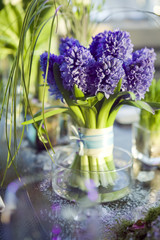 decoration of dining table.   bouquet of  hyacinth in vase of gl