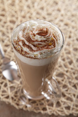 Coffee Latte whipped cream and cacao dust in rustic style