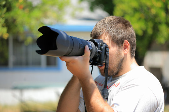 Photographer With Telephoto Lens Shooting Outdoors