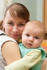 Portrait of happy newborn baby and mother