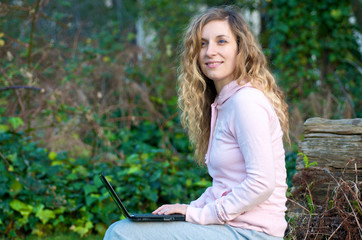 Naklejka na ściany i meble College Student studying outdoor with laptop