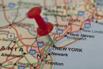 red push pin pointing on new york
