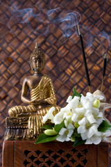 Buddha With Incense Sticks And Flowers