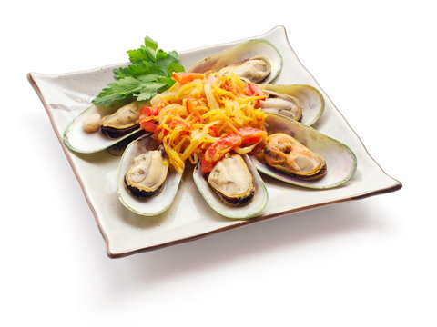 Mussel with tomato, carrot and parsley on the squared plate