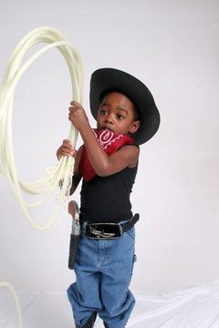 African American cowboy playing with a rope