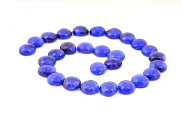 Blue glass stones over white background