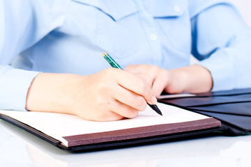 Businesswoman writing.