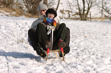 Fototapeta na wymiar sledding in the snow