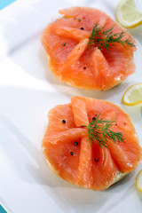 Smoked salmon on bagel with fresh black pepper.