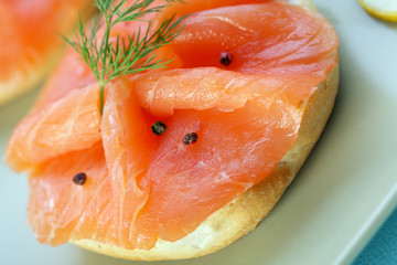 Smoke salmon on bagel with freshly black pepper.
