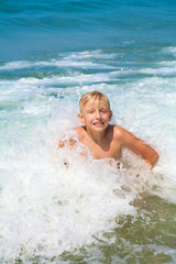 Little boy bathing on the sea