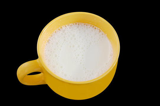 Fresh milk in big cup on black background with clipping path.