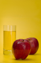 Juicy red apples on a yellow background