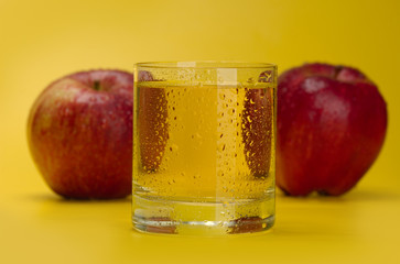 Juicy red apples on a yellow background