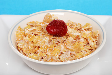 closeup of a bowl of flaky cereal with strawberry