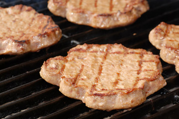 shallow DOF of hamburgers on a barbeque grill