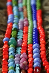 Color stones jewelry necklaces, straw background