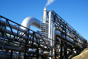 industrial pipelines on pipe-bridge against blue sky