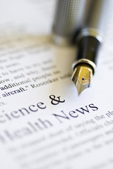 newspaper with pen