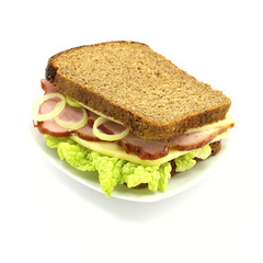 Sandwich with ham, cheese and vegetables on a white background