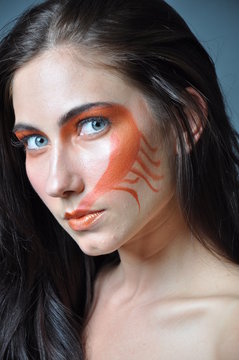 a fashion model with painted face