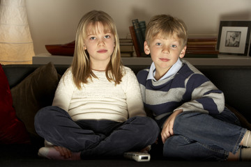 Brother And Sister Watching Television