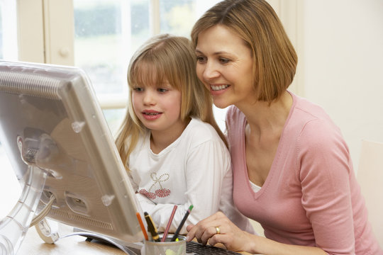 Woman And Daughter Using Computer