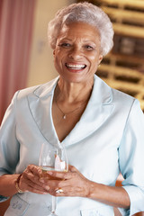 Woman Having A Glass Of Wine At A Bar