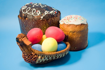 Easter cake and colourful easter eggs  on a blue background