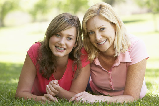 Woman Lying On The Ground With Her Teenage Daughter