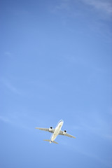 Commercial Airplane Flying Against A Blue Sky