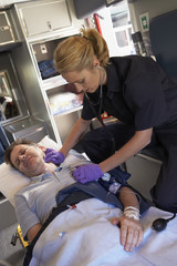 Paramedic with patient in ambulance