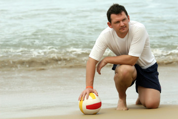 Fototapeta na wymiar Man with volleyball on the beach