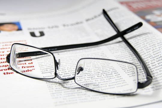 Reading glasses and business magazine
