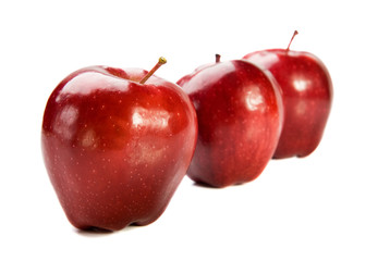 Three red apples on white background