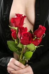 Beautiful woman body holding red roses