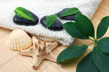 foldet white bath towel and zen stones