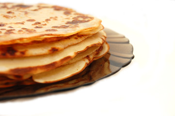 Plate with Russian pancakes on a white background