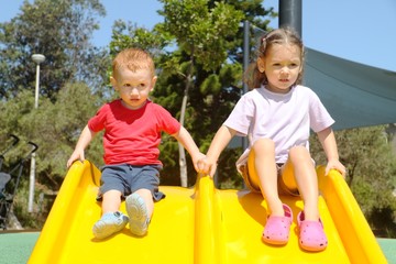 Fototapeta na wymiar Kids on slide