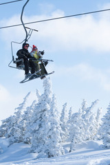 Fototapeta na wymiar Skiers on a ski lift