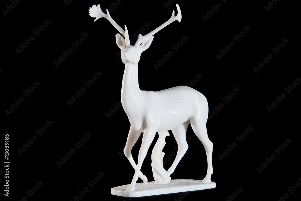 Wall mural classic white marble statuette of a deer isolated on black