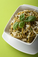 Italian pasta spaghetti with pesto sause and parmesan.