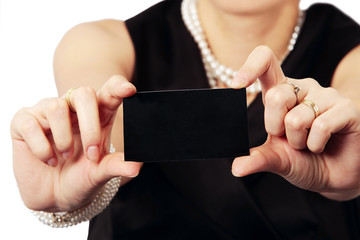 close up of black business card presented by stylish lady