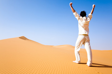 Fototapeta na wymiar Man standing on a sand dune