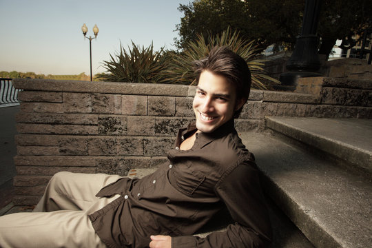 Man relaxing on a set of steps in the park