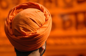 Sikh head in orange turban - obrazy, fototapety, plakaty