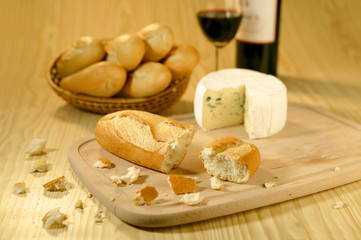 baguettes in a basket, cheese and wine