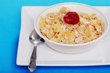 cereal with a strawberry and spoon