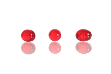 Red capsules isolated on white.