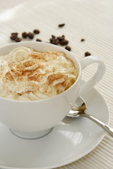 Cup of Cuppuccino with coffee beans